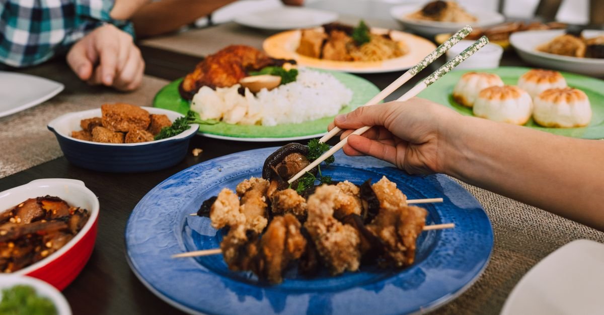Savor the appeal of Asian cuisine with diverse dishes and chopsticks in use for an authentic touch.
