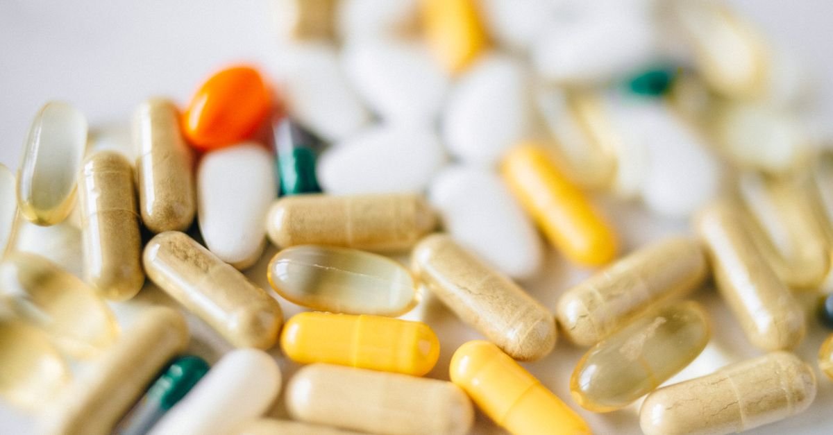 A close-up image of various pills and capsules showcasing diverse colors and types of pharmaceuticals.